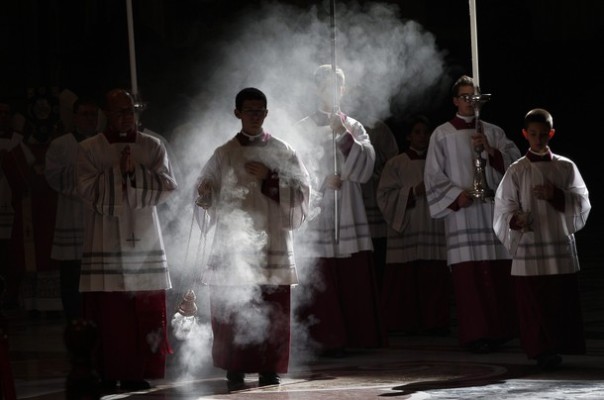 Altar boys arrive in procession during a mass celebrated by Pope Benedict XVI to commemorate cardinals and bishops who died this year, at the Vatican